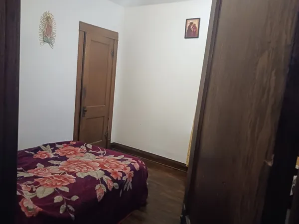 a bedroom with a bed and a mirror