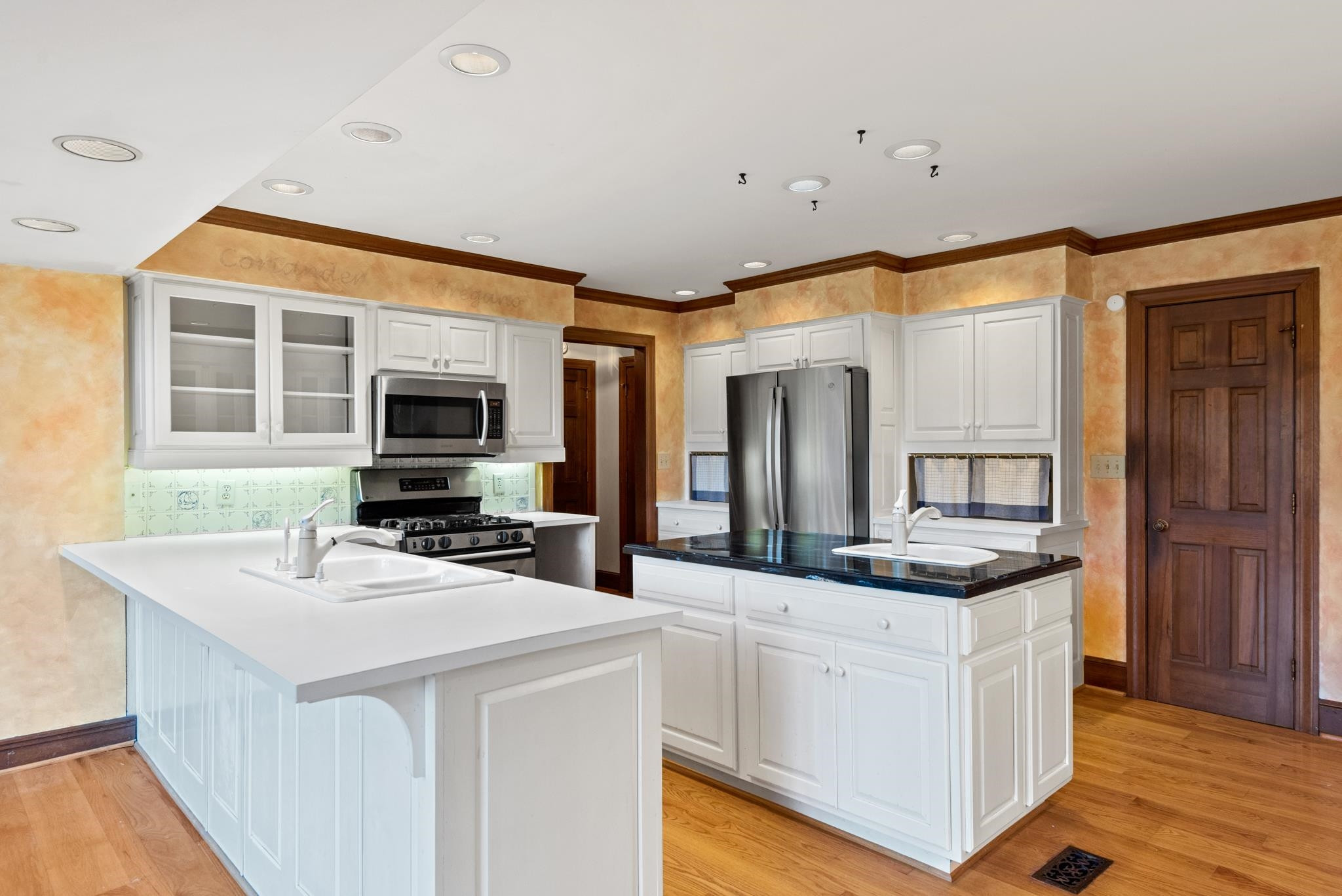 1704 Hunting Ridge Road Raleigh, NC 27615 - Photo 19 of 43 a kitchen with stainless steel appliances a stove a sink and a microwave