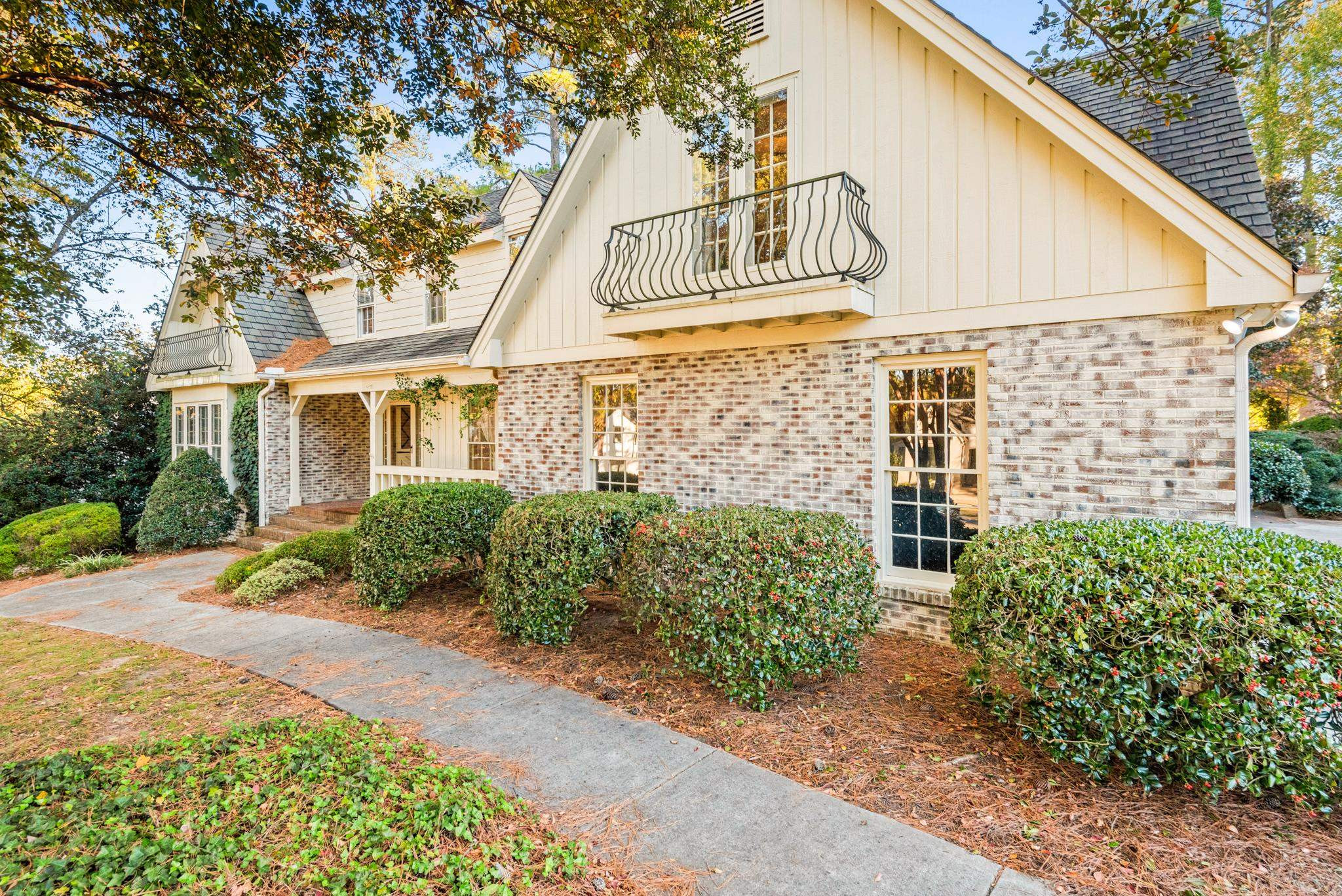 1704 Hunting Ridge Road Raleigh, NC 27615 - Photo 2 of 43 a view of a white house with a large windows and flower plants