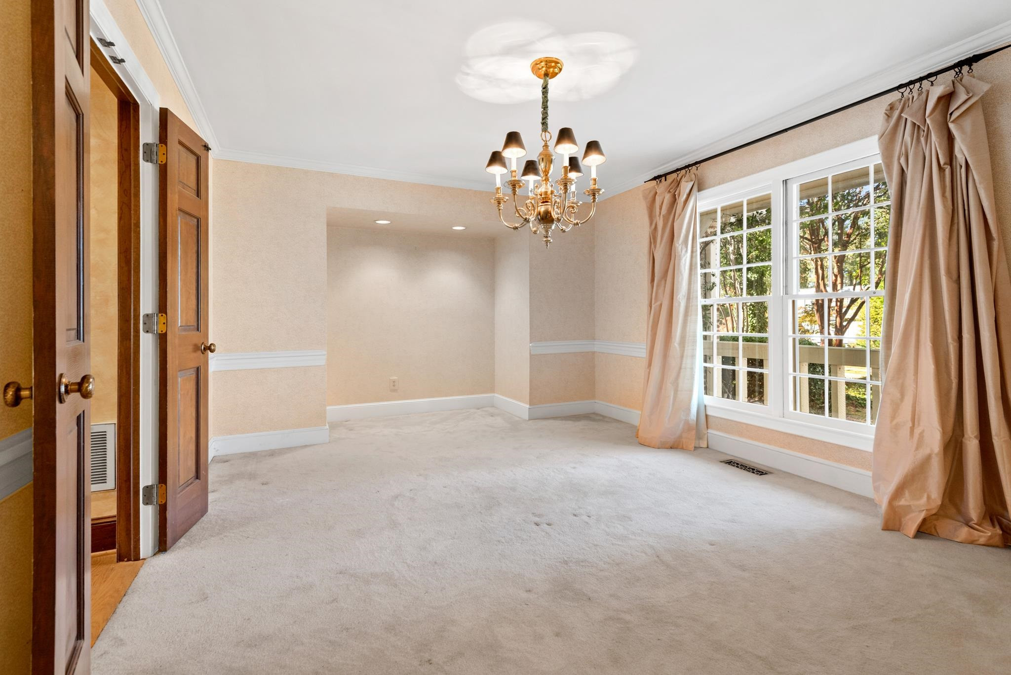1704 Hunting Ridge Road Raleigh, NC 27615 - Photo 8 of 43 a view of an empty room with a window