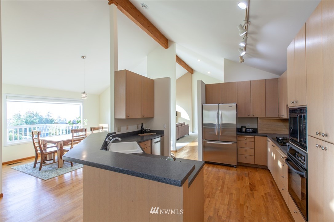 629 Briar Road Bellingham, WA 98225 - Photo 14 of 31 a kitchen with stainless steel appliances granite countertop a sink counter space and wooden floor