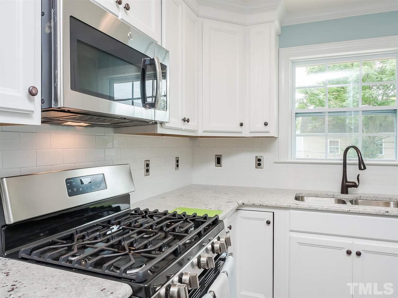 721 South State Street Raleigh, NC 27601 - Photo 6 of 25 a kitchen with white cabinets and appliances