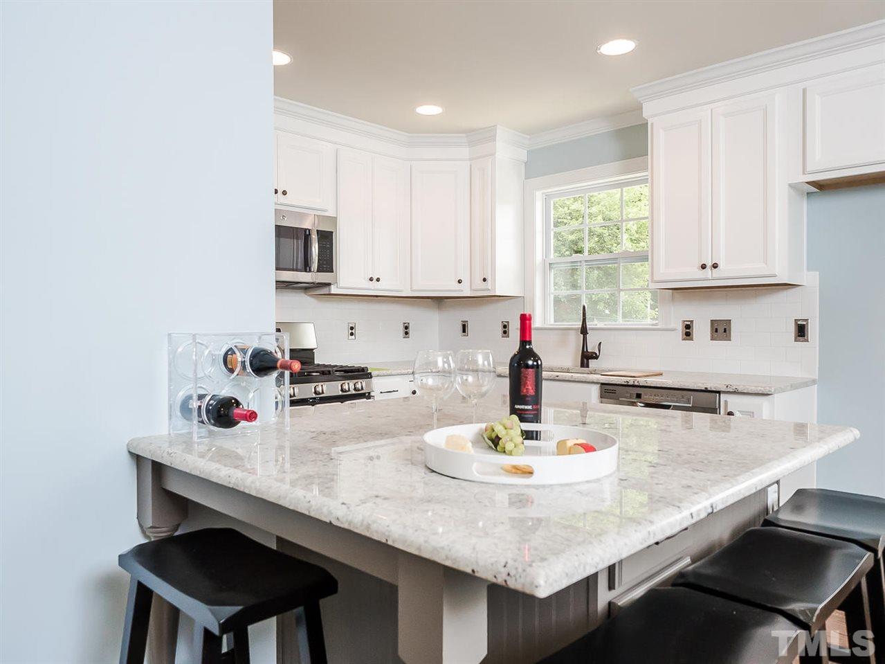 721 South State Street Raleigh, NC 27601 - Photo 7 of 25 a kitchen with a sink a stove and white cabinets