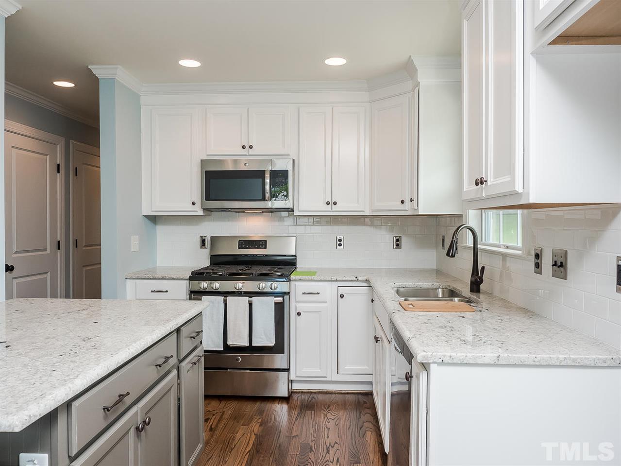 721 South State Street Raleigh, NC 27601 - Photo 8 of 25 a kitchen with granite countertop a sink and a stove top oven