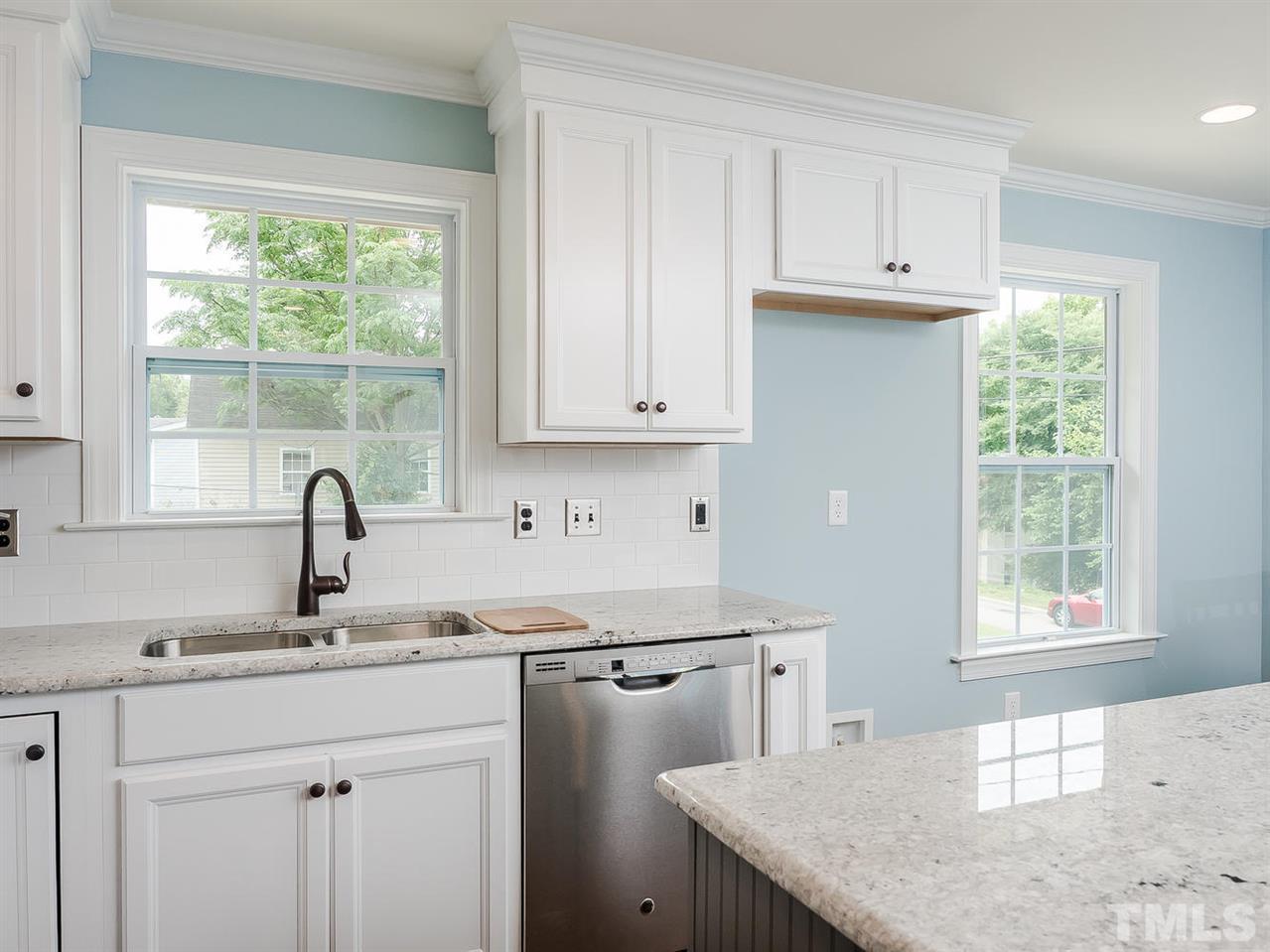 721 South State Street Raleigh, NC 27601 - Photo 9 of 25 a kitchen with stainless steel appliances granite countertop a sink a window and white cabinets