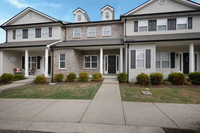 a front view of a house with a yard