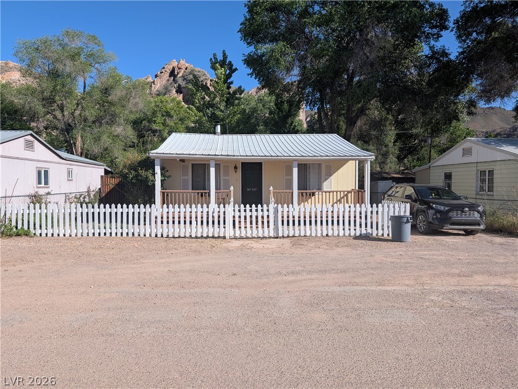 107 Rowan Drive Caliente, NV 89008 - Photo 1 of 23 This charming home offers a quaint retreat with a welcoming porch and white picket fence.