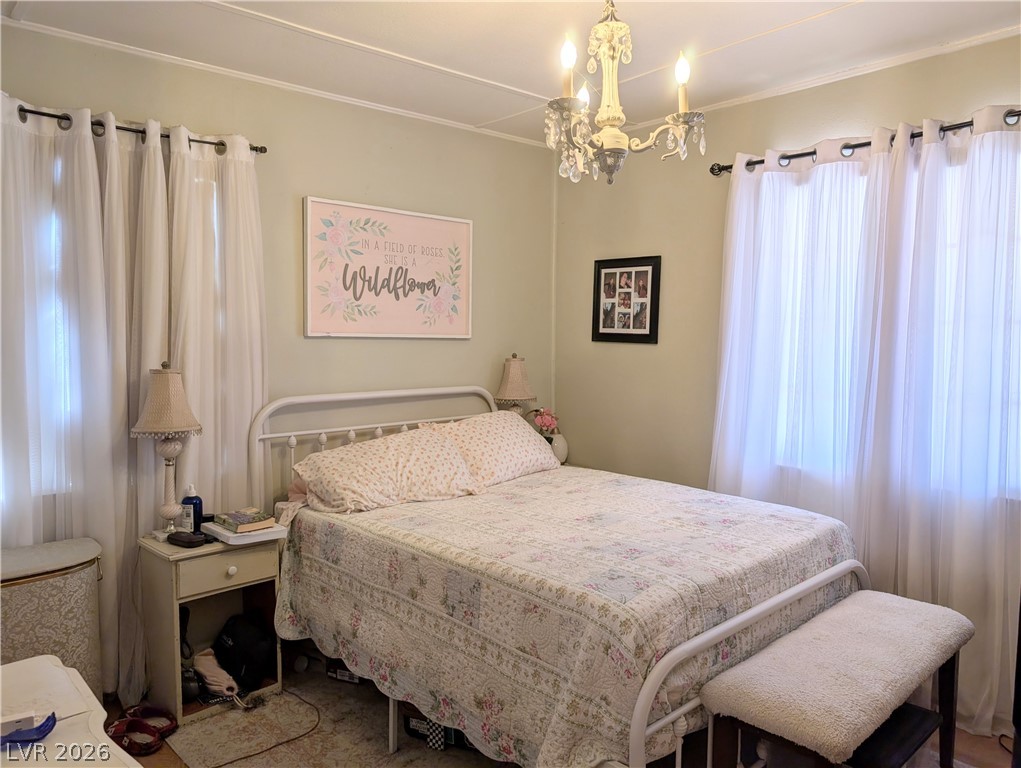 107 Rowan Drive Caliente, NV 89008 - Photo 11 of 23 This cozy bedroom offers a tranquil retreat with soft lighting and comfortable furnishings.