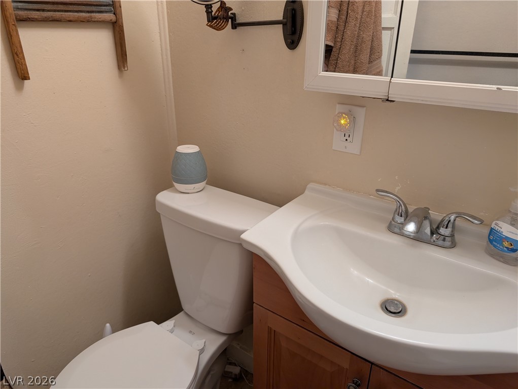 107 Rowan Drive Caliente, NV 89008 - Photo 16 of 23 This bathroom features a sleek sink and a classic toilet, offering functionality and simple design.