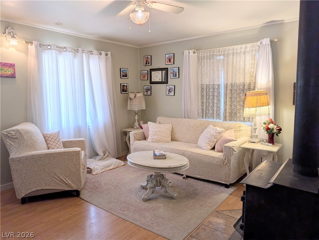 107 Rowan Drive Caliente, NV 89008 - Photo 2 of 23 This inviting living area features warm flooring, a charming ceiling fan, and abundant natural light.