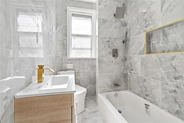 a bathroom with a bathtub sink and toilet