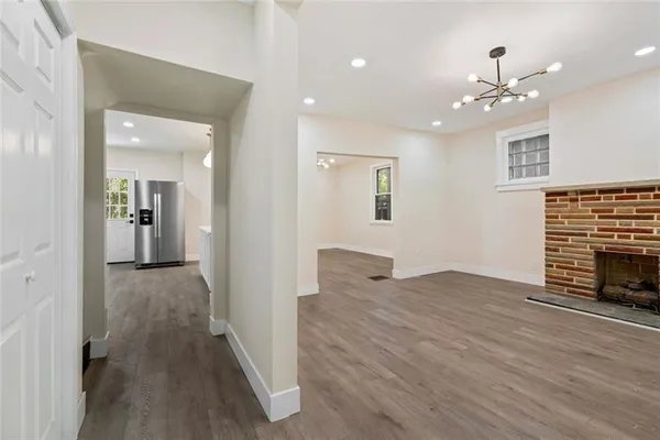 wooden floor in an empty room with a fireplace