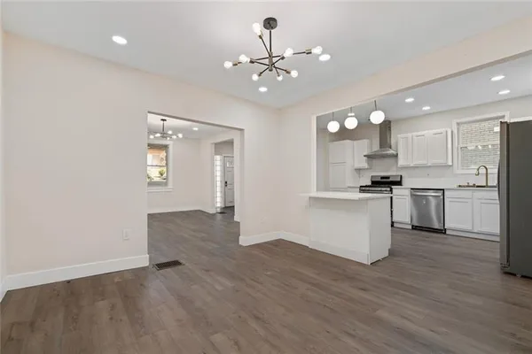 a view of kitchen with sink and refrigerator