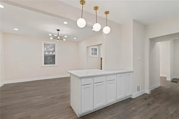 a view of a kitchen sink and dishwasher with wooden floor