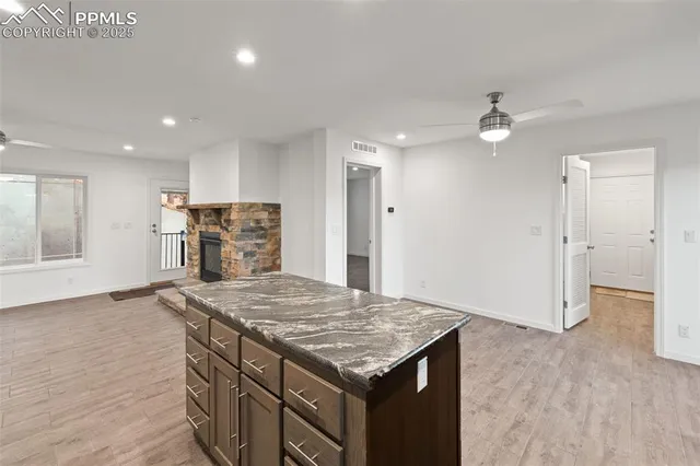 a kitchen with stainless steel appliances granite countertop a stove a sink and a refrigerator