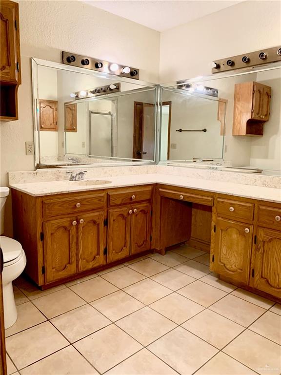 1311 East Pine Avenue Pharr, TX 78577 - Photo 11 of 14 a kitchen with a sink stove and cabinets