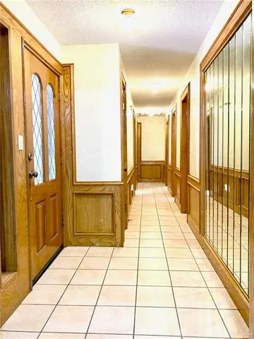 a view of empty room with a fireplace and a window