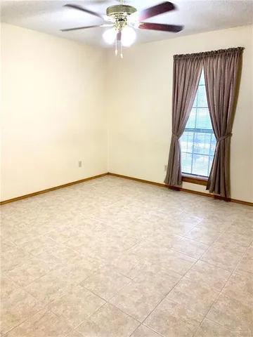a view of a room with wooden floor and a window