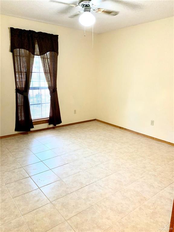 1311 East Pine Avenue Pharr, TX 78577 - Photo 10 of 14 a view of a room with wooden floor and a window