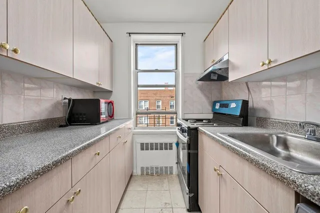 a kitchen with stainless steel appliances granite countertop a sink stove and cabinets
