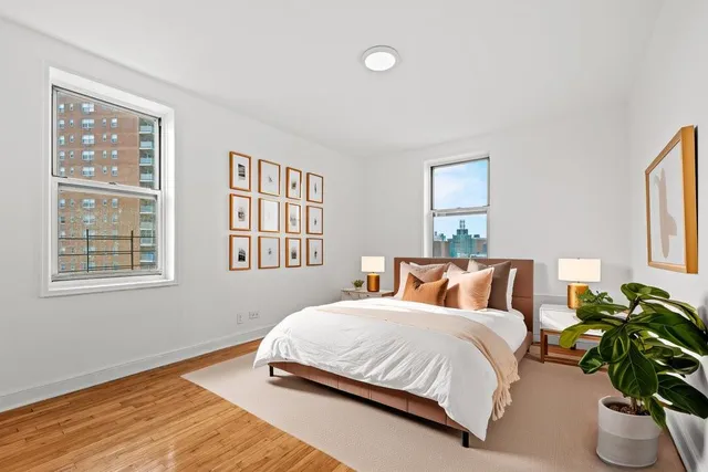 a bedroom with a bed lamp and window