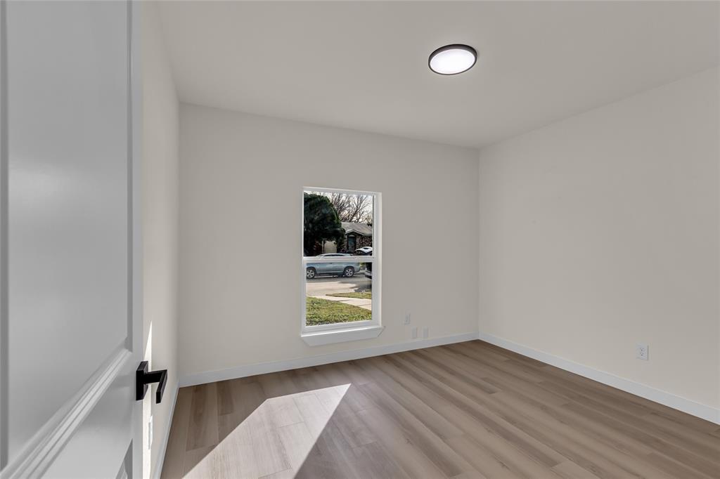 913 Roaming Rd Drive Allen, TX 75002 - Photo 13 of 21 a view of an empty room window and wooden floor