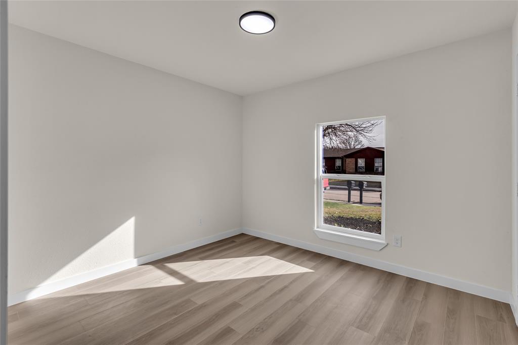 913 Roaming Rd Drive Allen, TX 75002 - Photo 14 of 21 an empty room with wooden floor and windows