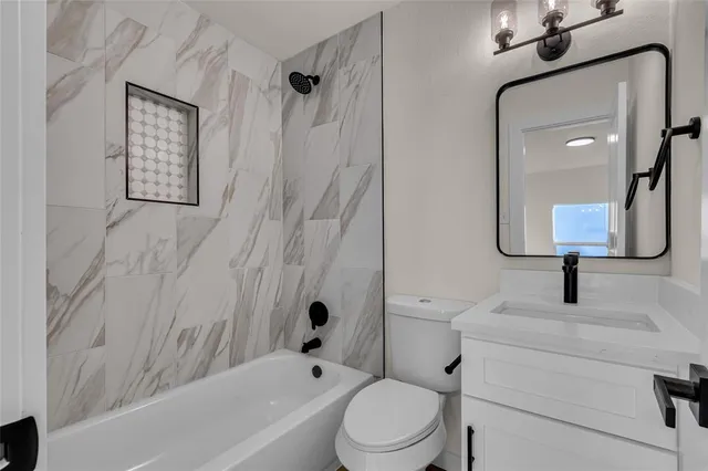 a bathroom with a toilet sink and bathtub