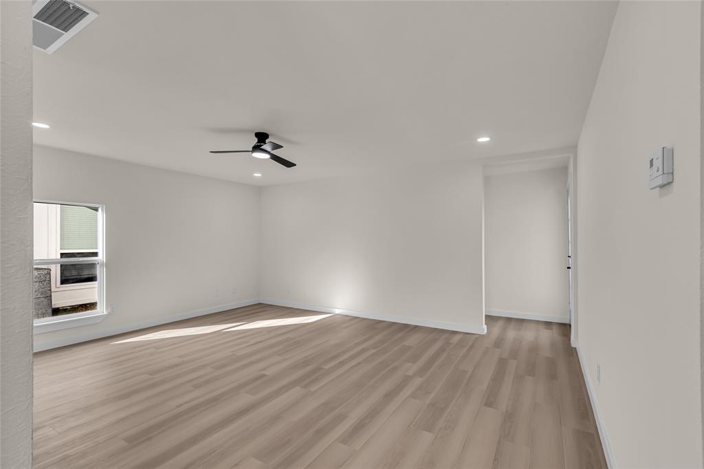 913 Roaming Rd Drive Allen, TX 75002 - Photo 3 of 21 wooden floor in an empty room with a window