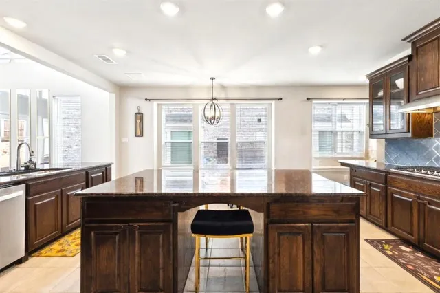 a kitchen with granite countertop a sink and a stove