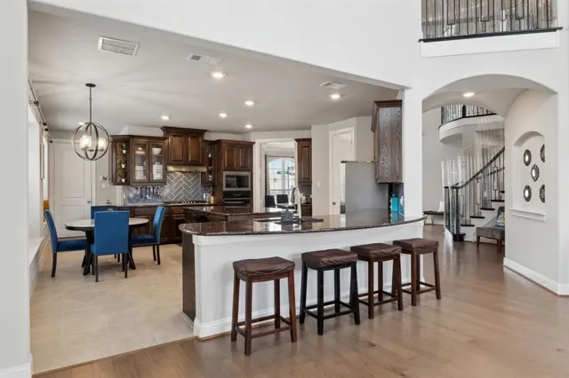 a large kitchen with a table and chairs