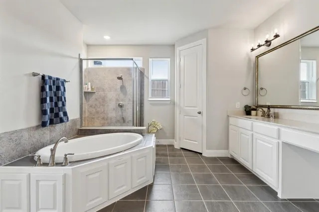 a bathroom with a tub sink and mirror