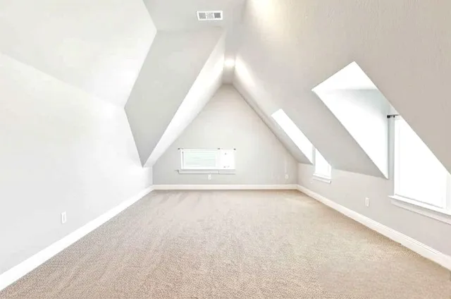 a view of a big room with wooden floor and windows