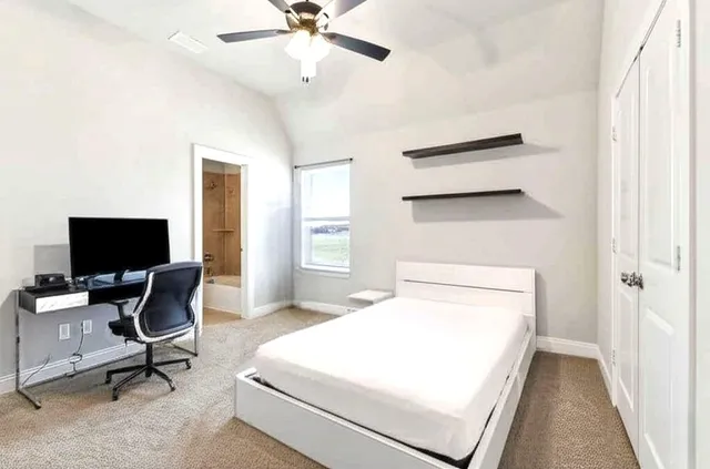 a bedroom with a bed and a flat screen tv