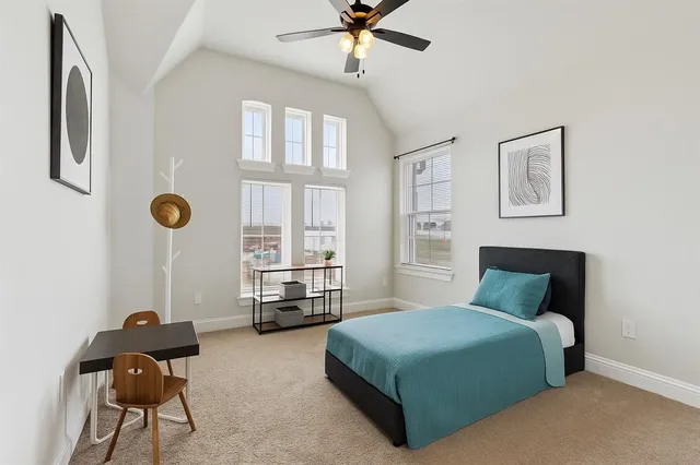 a bedroom with a bed a window and a chandelier