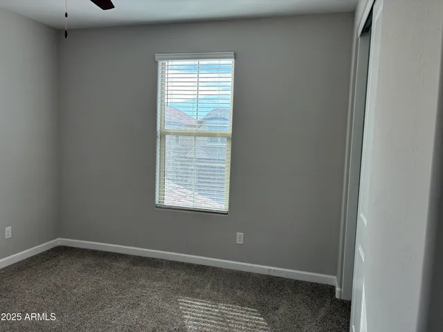 a view of a hallway with wooden floor and closet