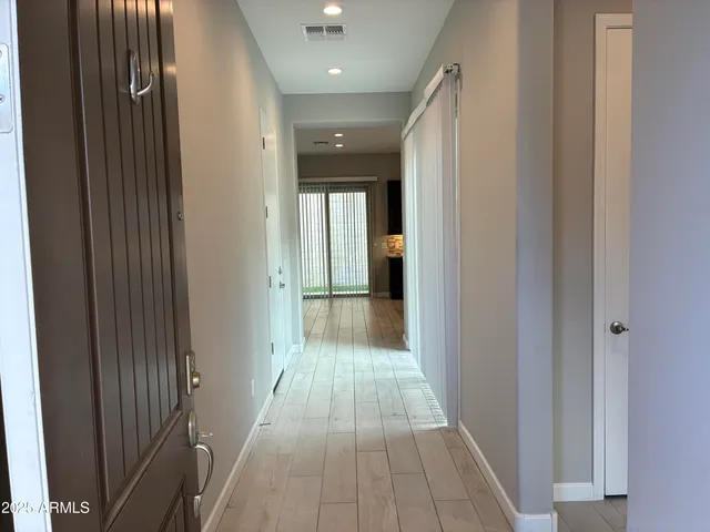 a view of a hallway with wooden floor