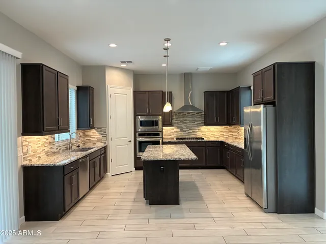 a kitchen with granite countertop counter top space a sink stainless steel appliances and cabinets