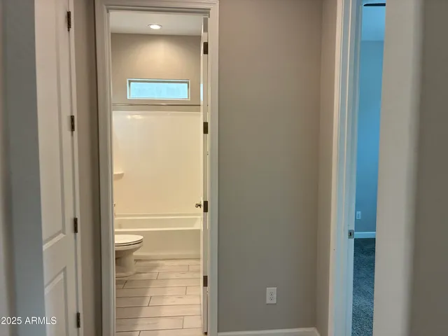 a bathroom with a glass door and a shower