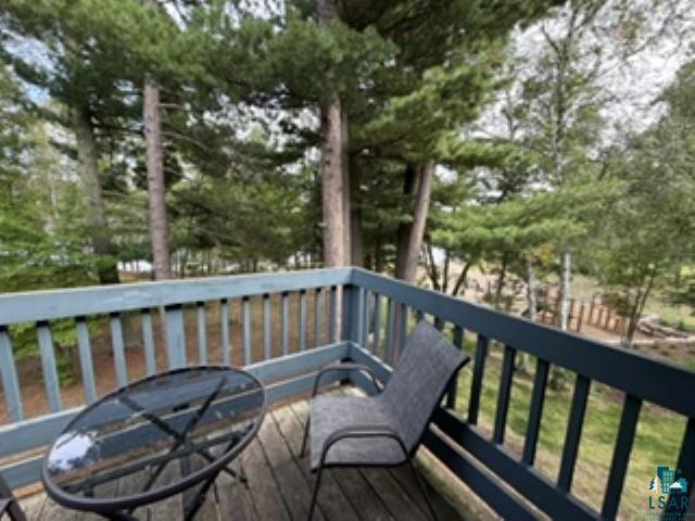 6266 Giants Ridge Road Biwabik, MN 55705 - Photo 5 of 30 Wood-deck balcony featuring painted railings and a wooded backdrop