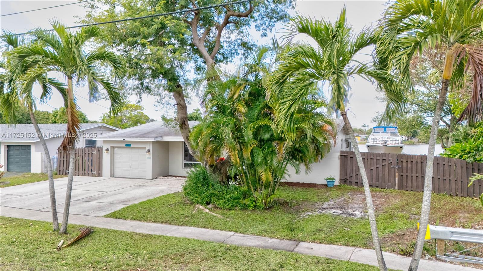 7271 Sunset Strip Sunrise, FL 33313 - Photo 1 of 45 a front view of a house with a yard and garage