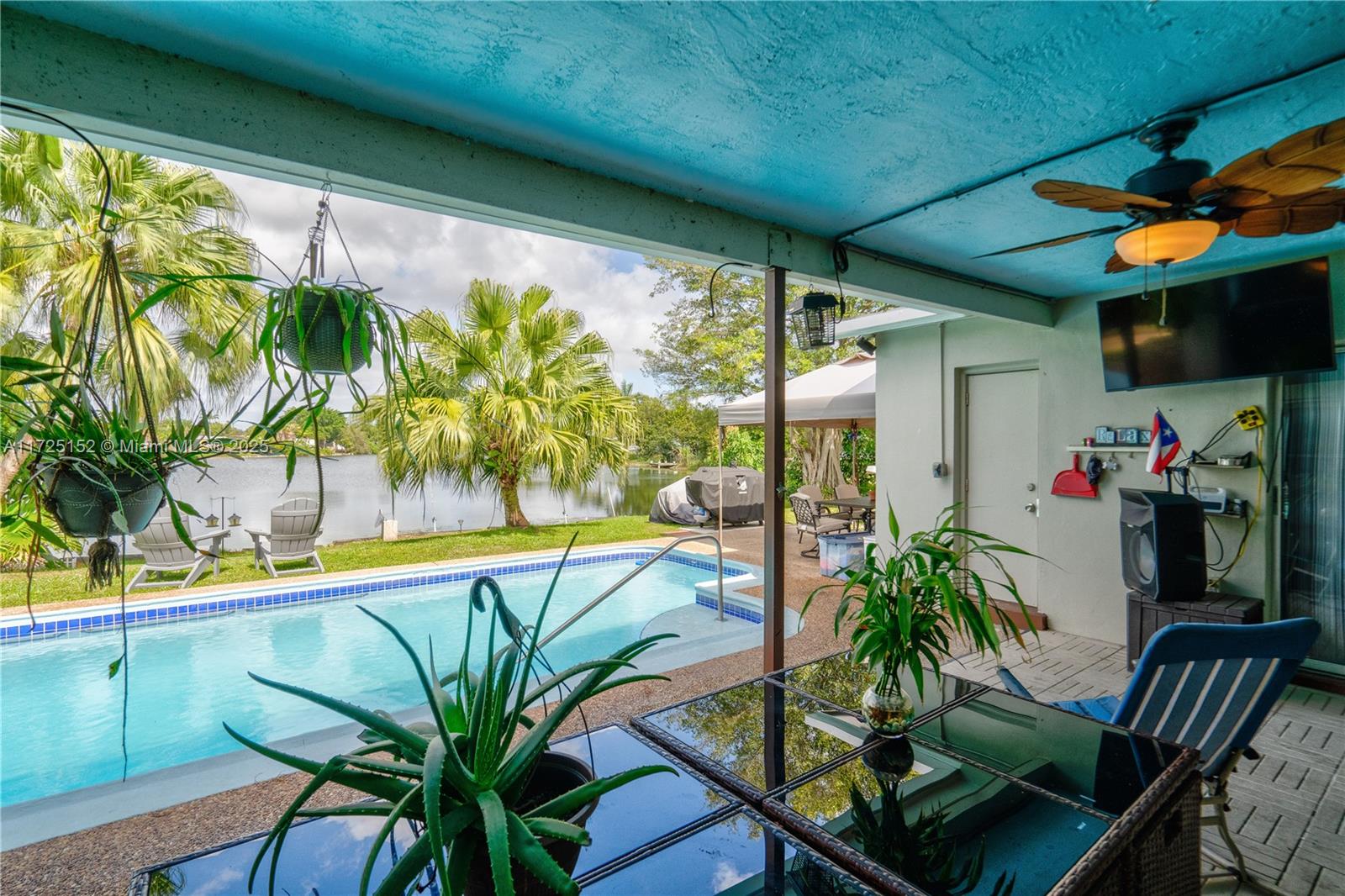 7271 Sunset Strip Sunrise, FL 33313 - Photo 13 of 45 a view of a swimming pool with chairs in patio