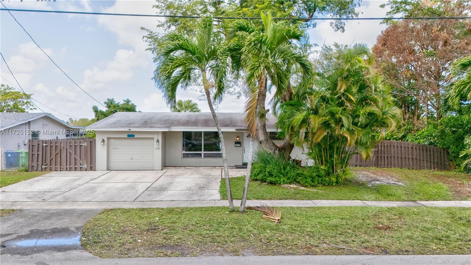 7271 Sunset Strip Sunrise, FL 33313 - Photo 14 of 45 front view of a house with a garden