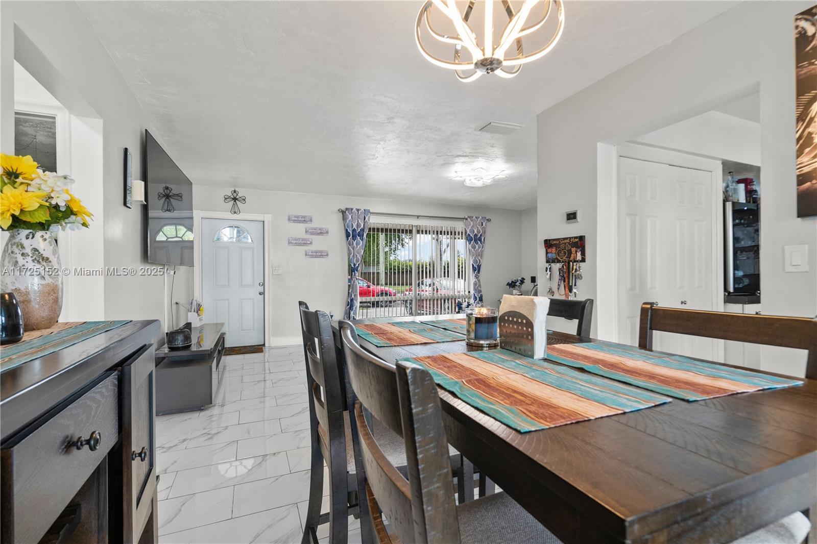 7271 Sunset Strip Sunrise, FL 33313 - Photo 15 of 45 a view of a dining room with furniture and a chandelier
