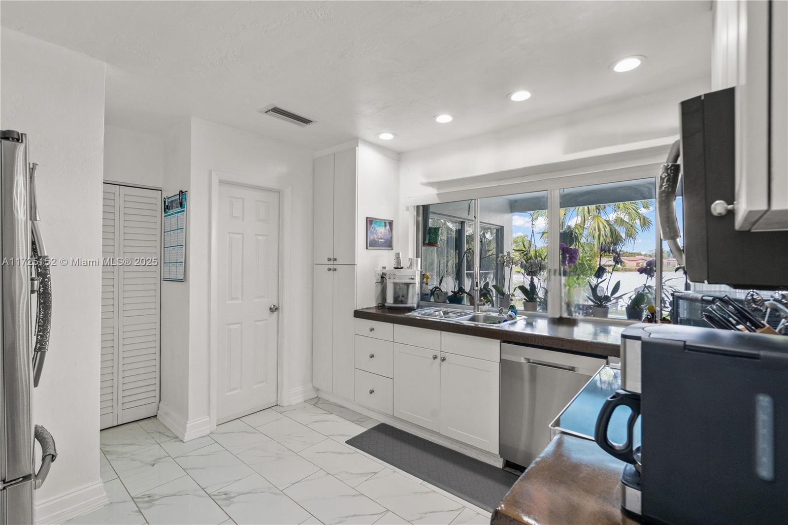 7271 Sunset Strip Sunrise, FL 33313 - Photo 17 of 45 a kitchen with sink cabinets and refrigerator