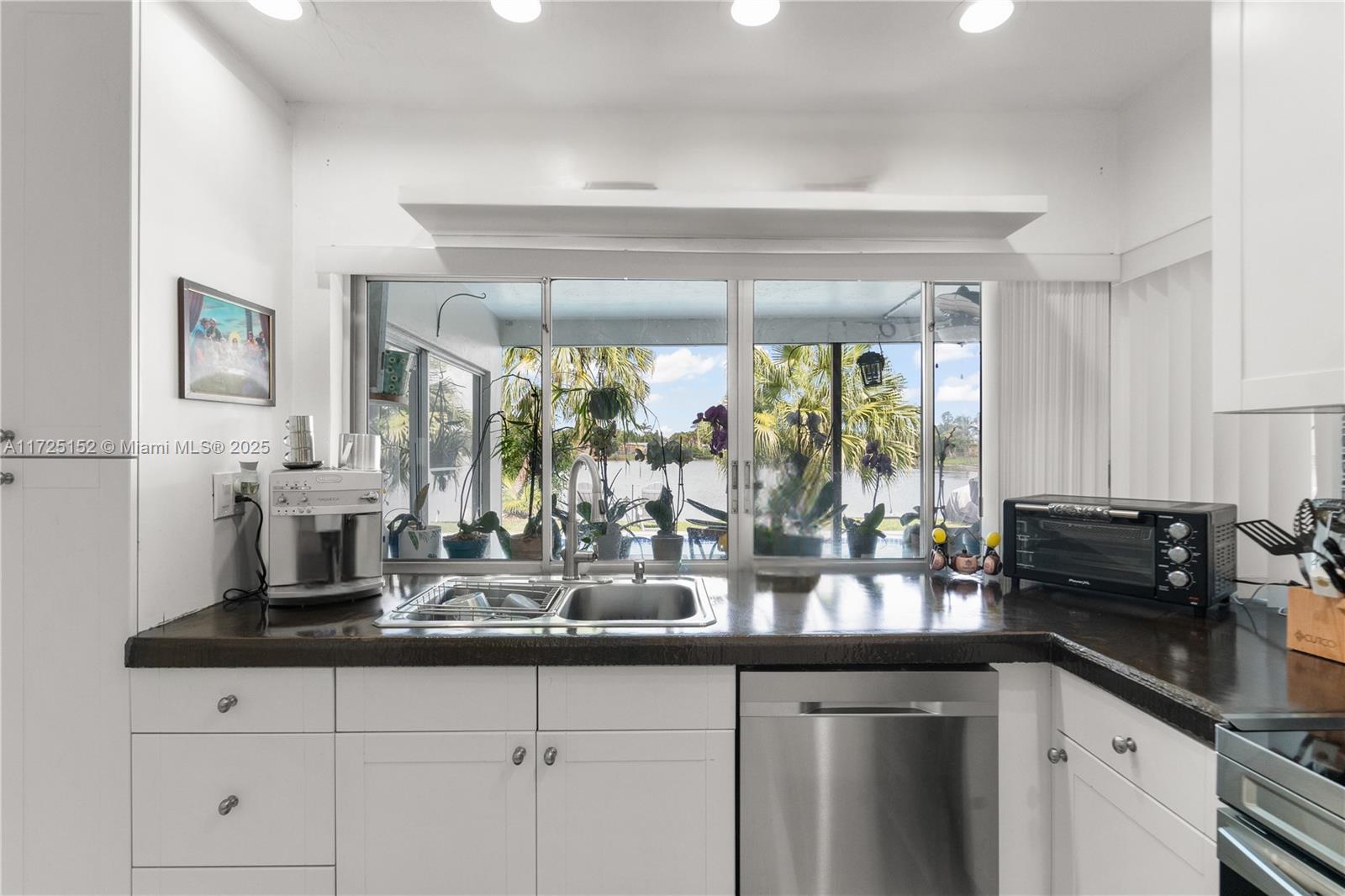 7271 Sunset Strip Sunrise, FL 33313 - Photo 18 of 45 a kitchen with sink and large window