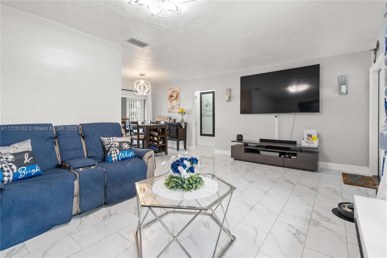 7271 Sunset Strip Sunrise, FL 33313 - Photo 20 of 45 a living room with furniture and a flat screen tv
