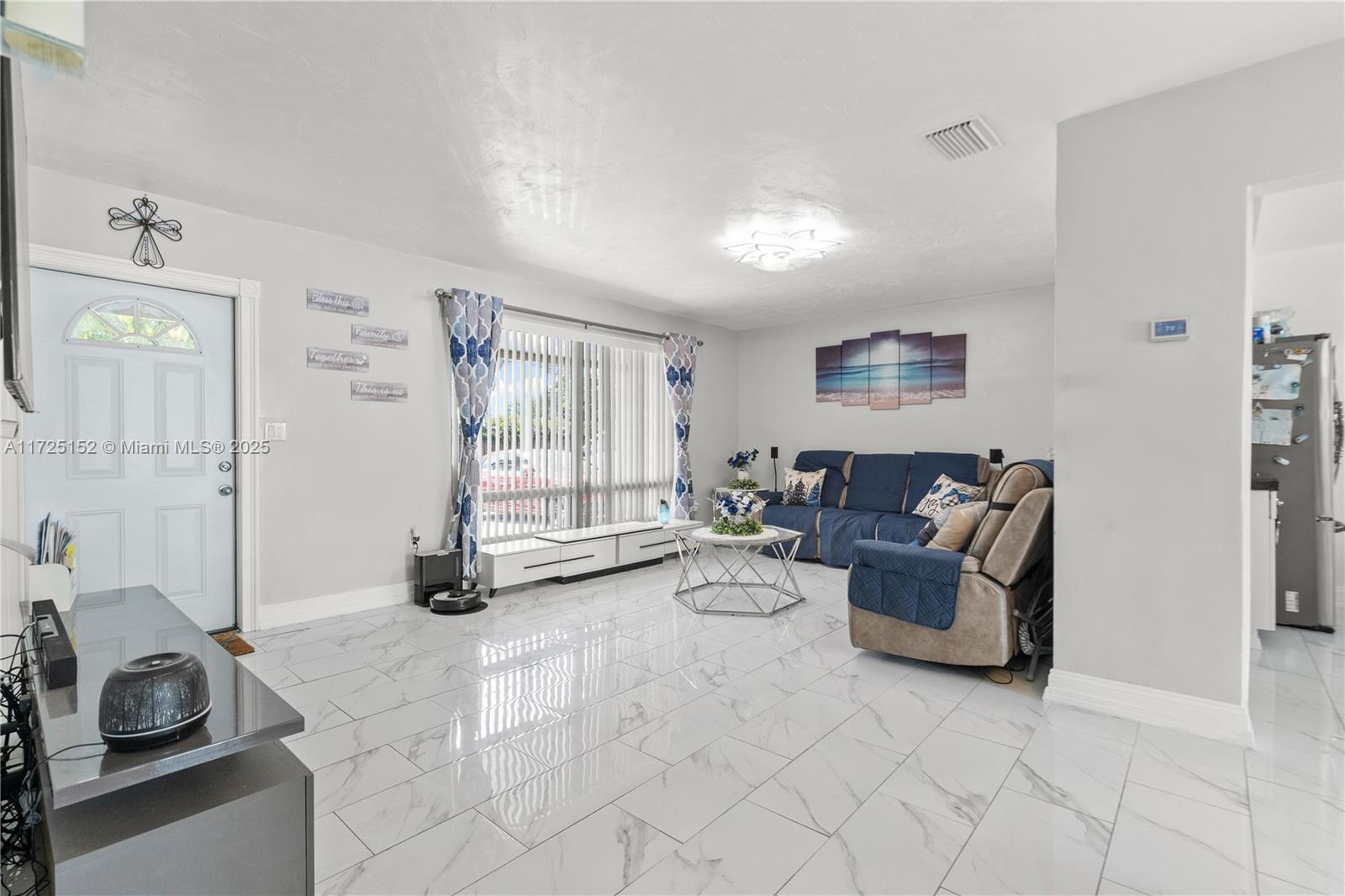 7271 Sunset Strip Sunrise, FL 33313 - Photo 21 of 45 a living room with furniture and a window