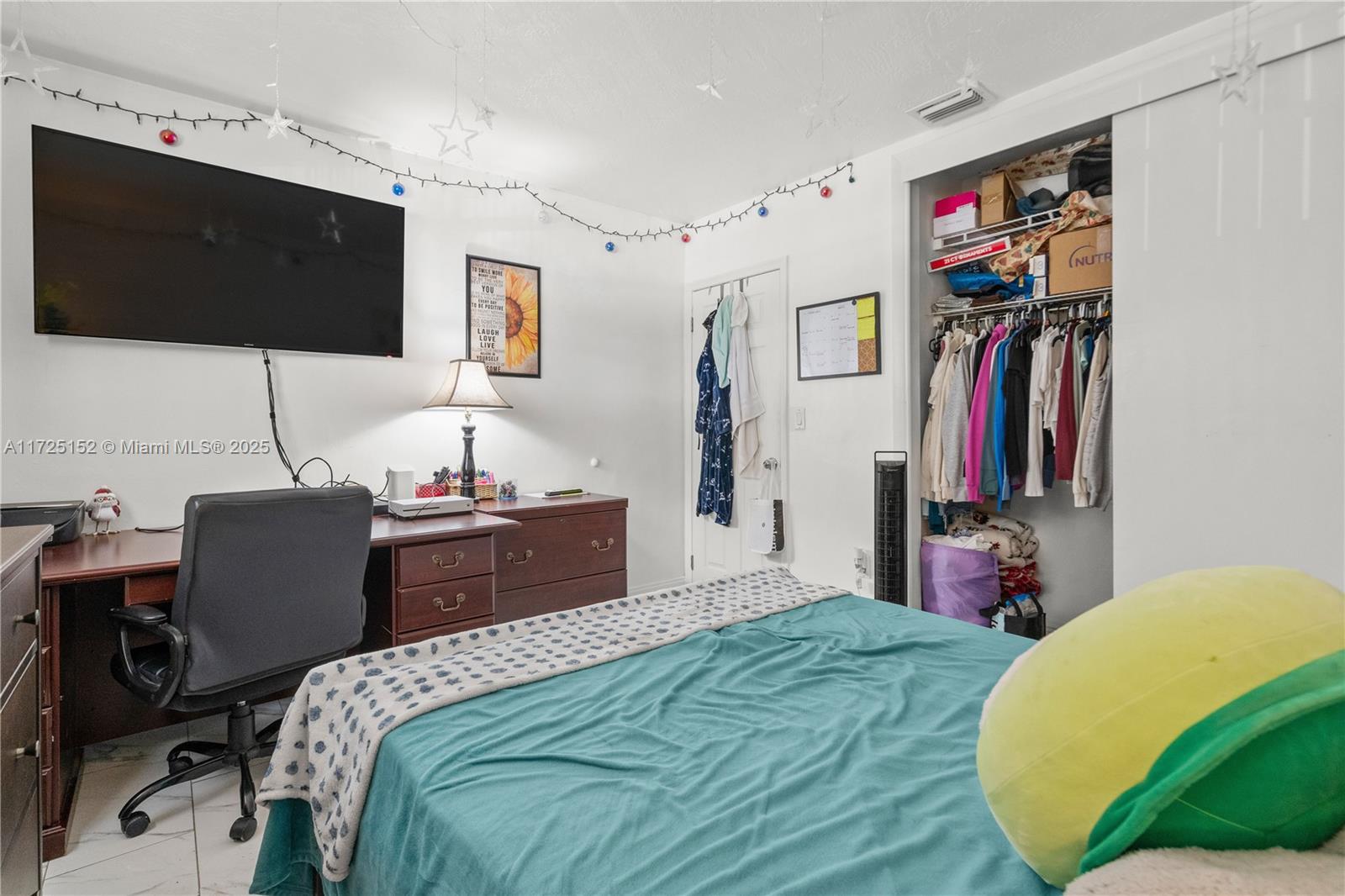7271 Sunset Strip Sunrise, FL 33313 - Photo 27 of 45 a bedroom with a bed and a flat screen tv