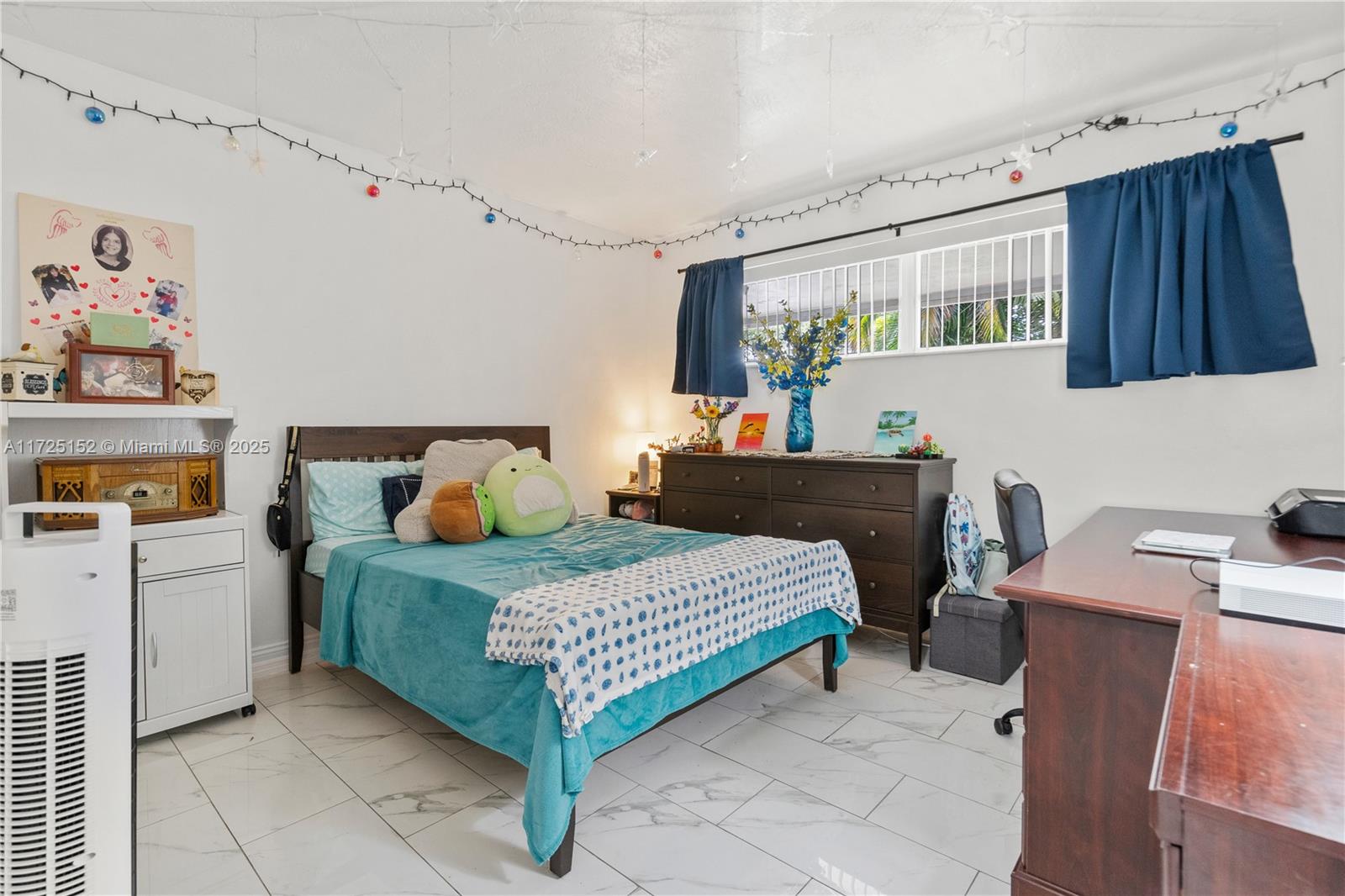 7271 Sunset Strip Sunrise, FL 33313 - Photo 28 of 45 a bedroom with a bed and a table in it